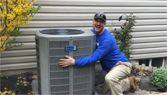 Technician Hugging Ac Unit