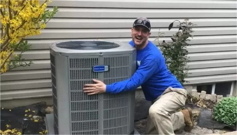 Technician Hugging Ac Unit@2x